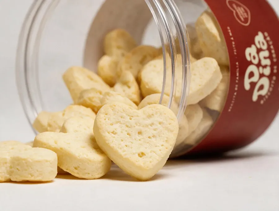 Close-up of heart-shaped biscuits spilling from a jar
